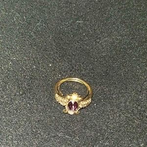 Golden ring with a purple diamond